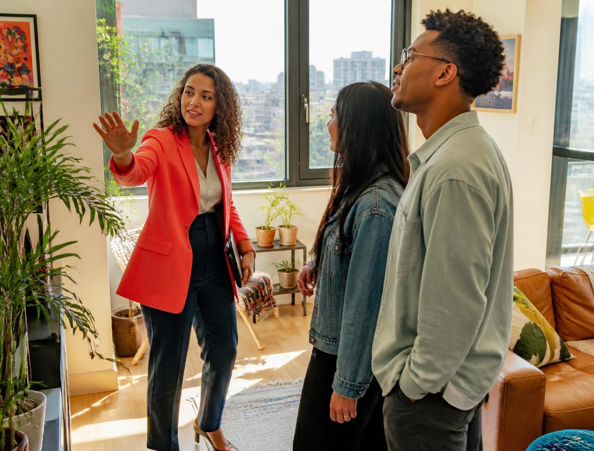 A landlord showing a tenant around a bright, freshly painted flat