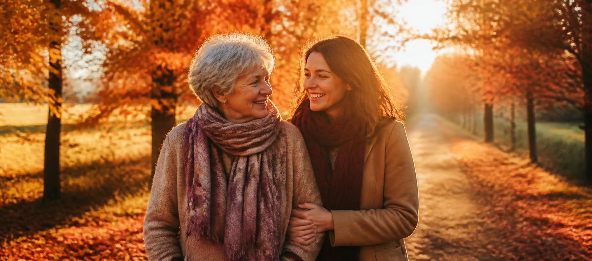 An older couple walking a tree-lined path at golden hour